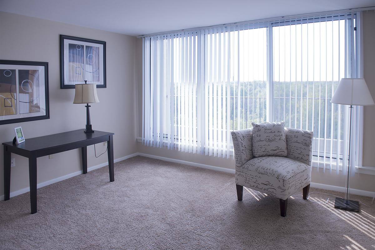 a living room filled with furniture and a large window