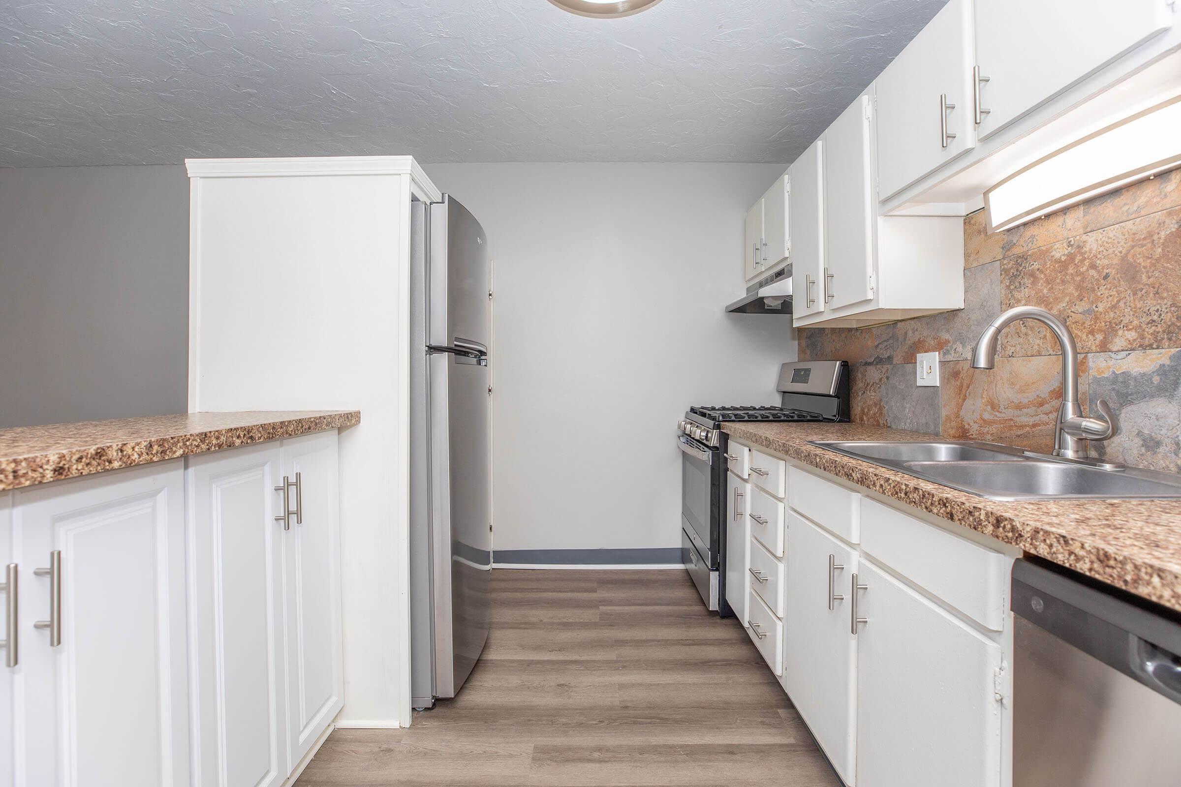 a kitchen with a stove and a sink