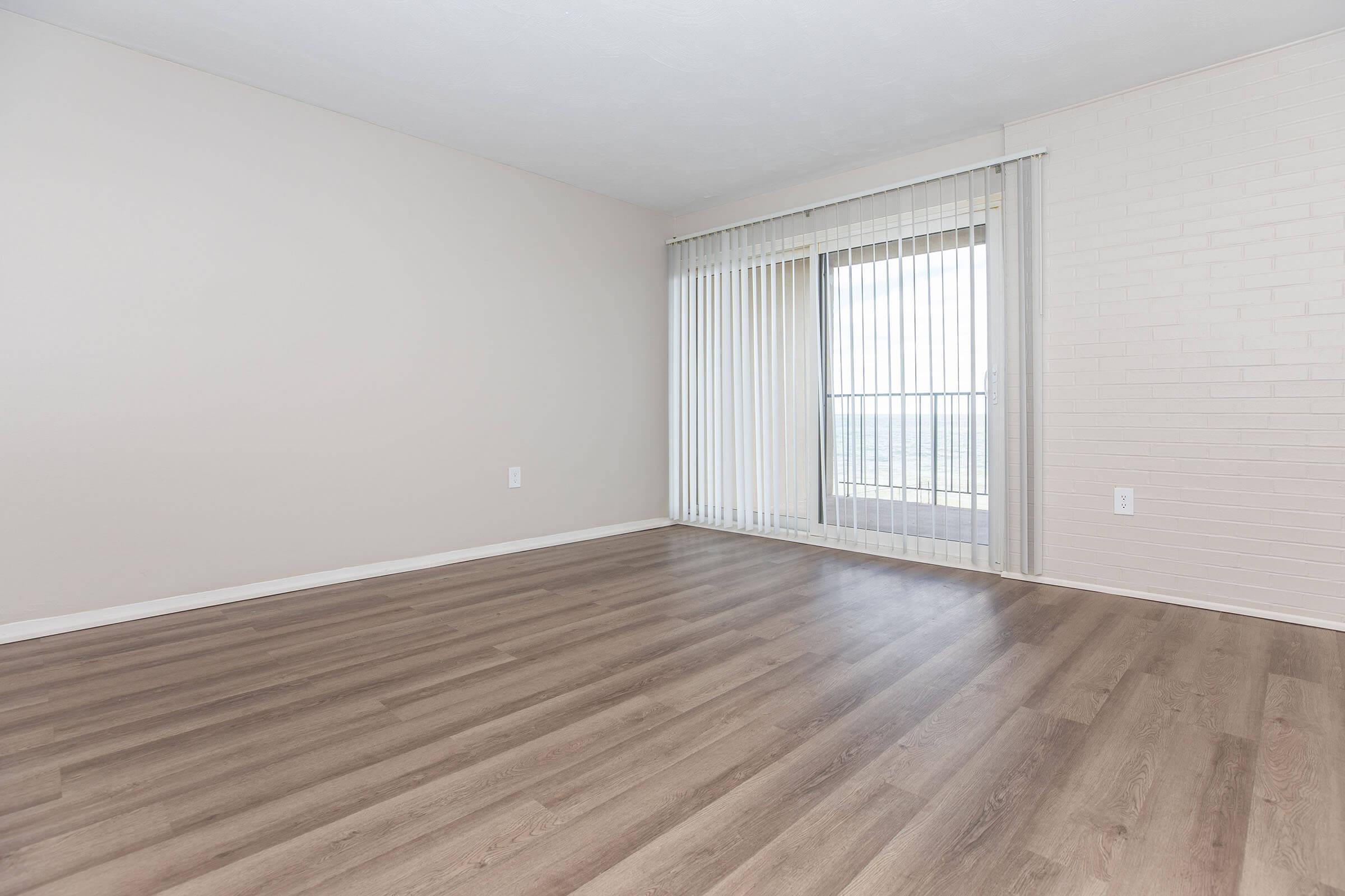 a large empty room with a wooden floor