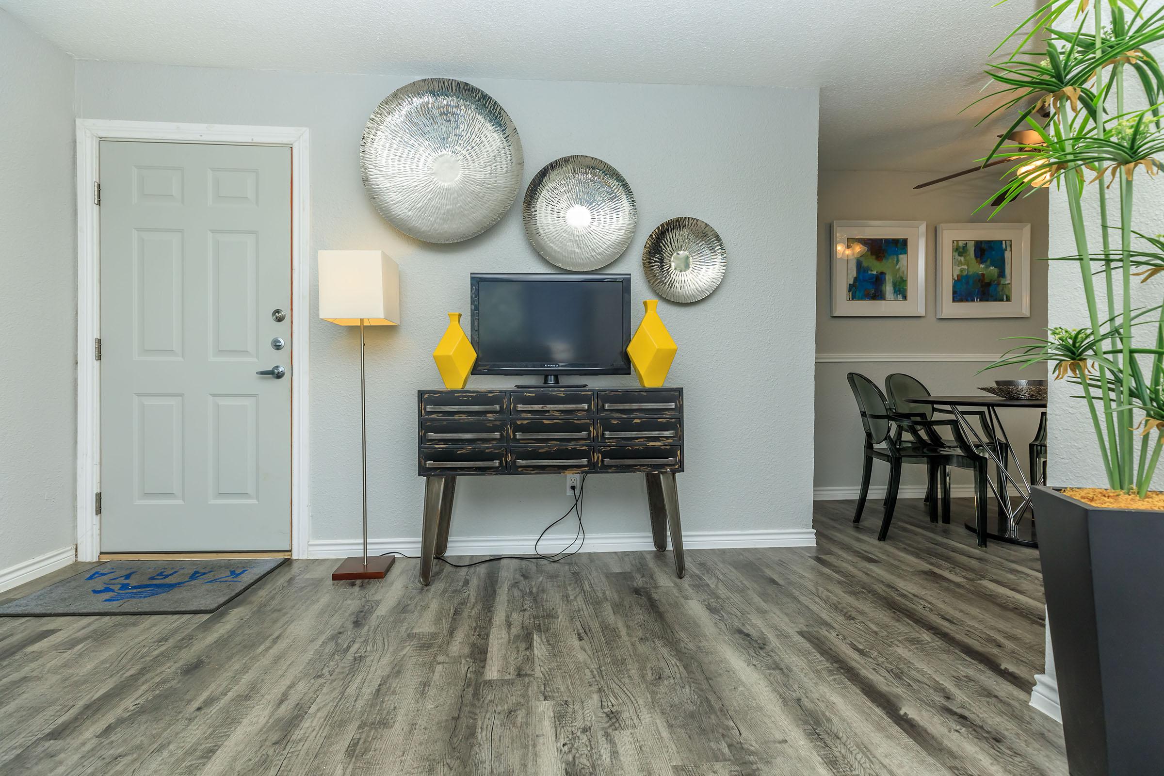 a living room filled with furniture and a clock