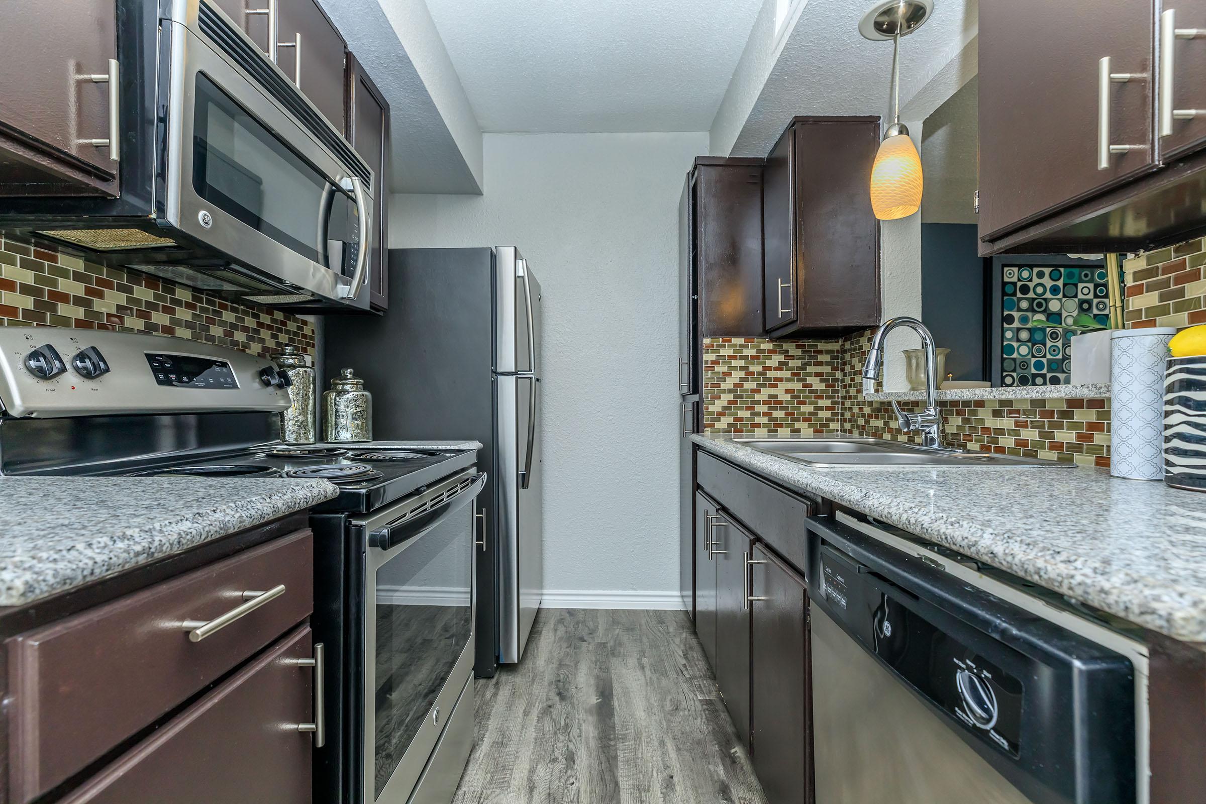 a large kitchen with stainless steel appliances