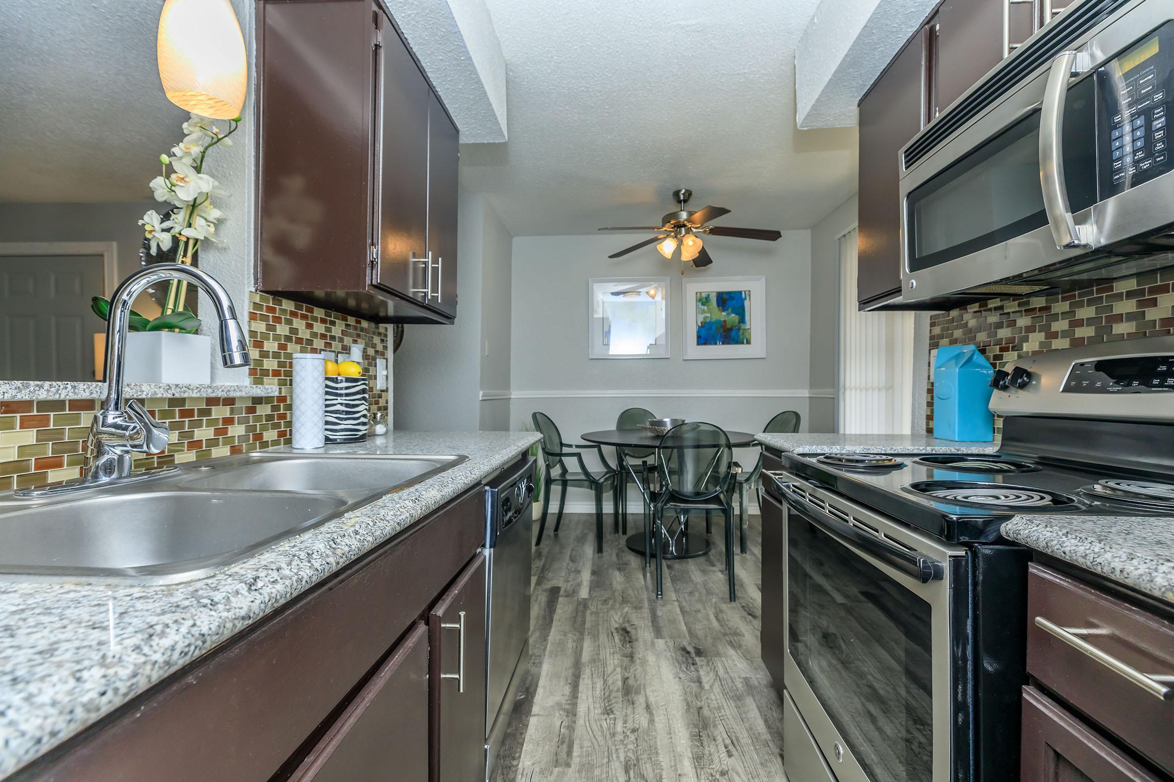 a kitchen with a sink and a mirror