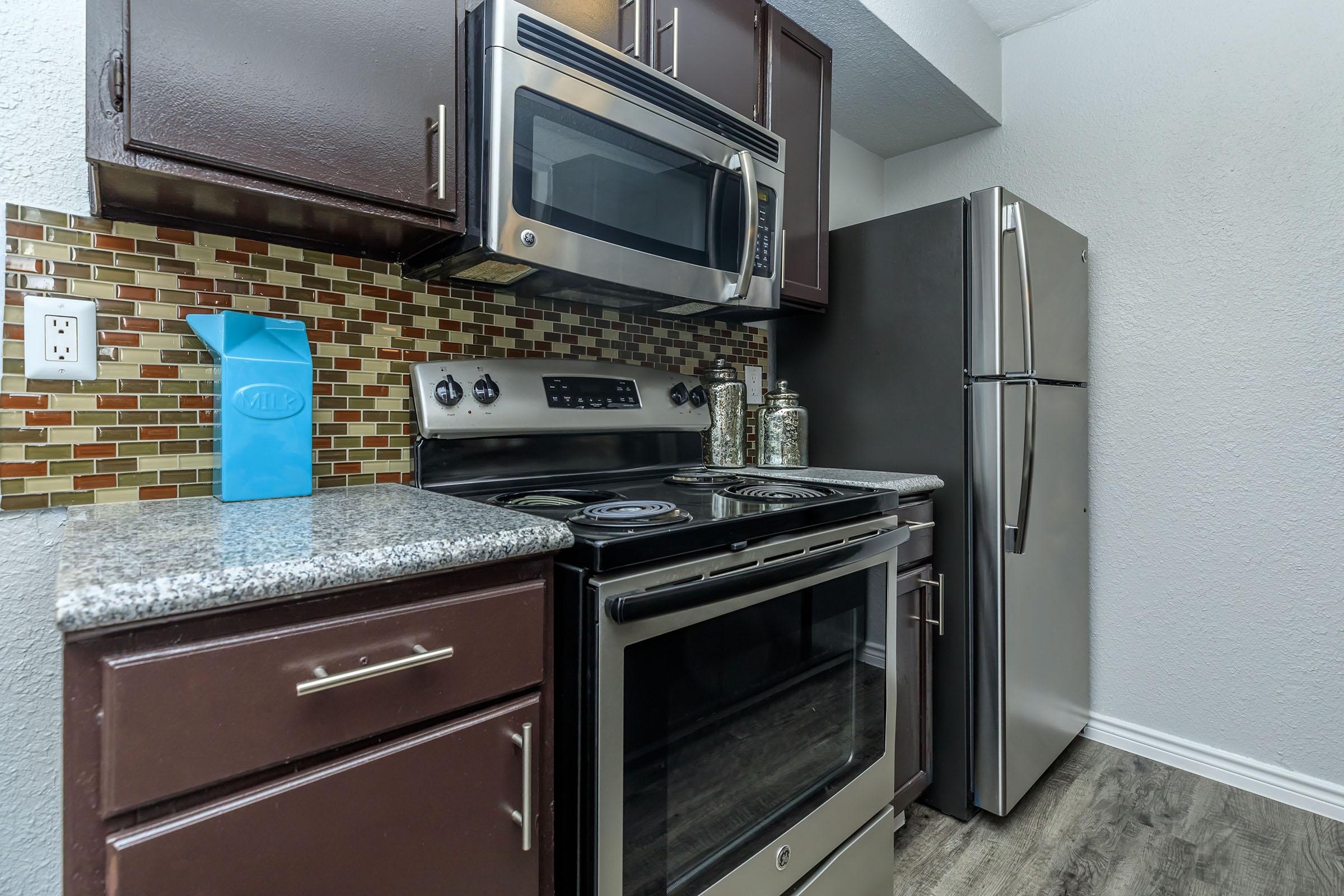 a stove top oven sitting inside of a kitchen