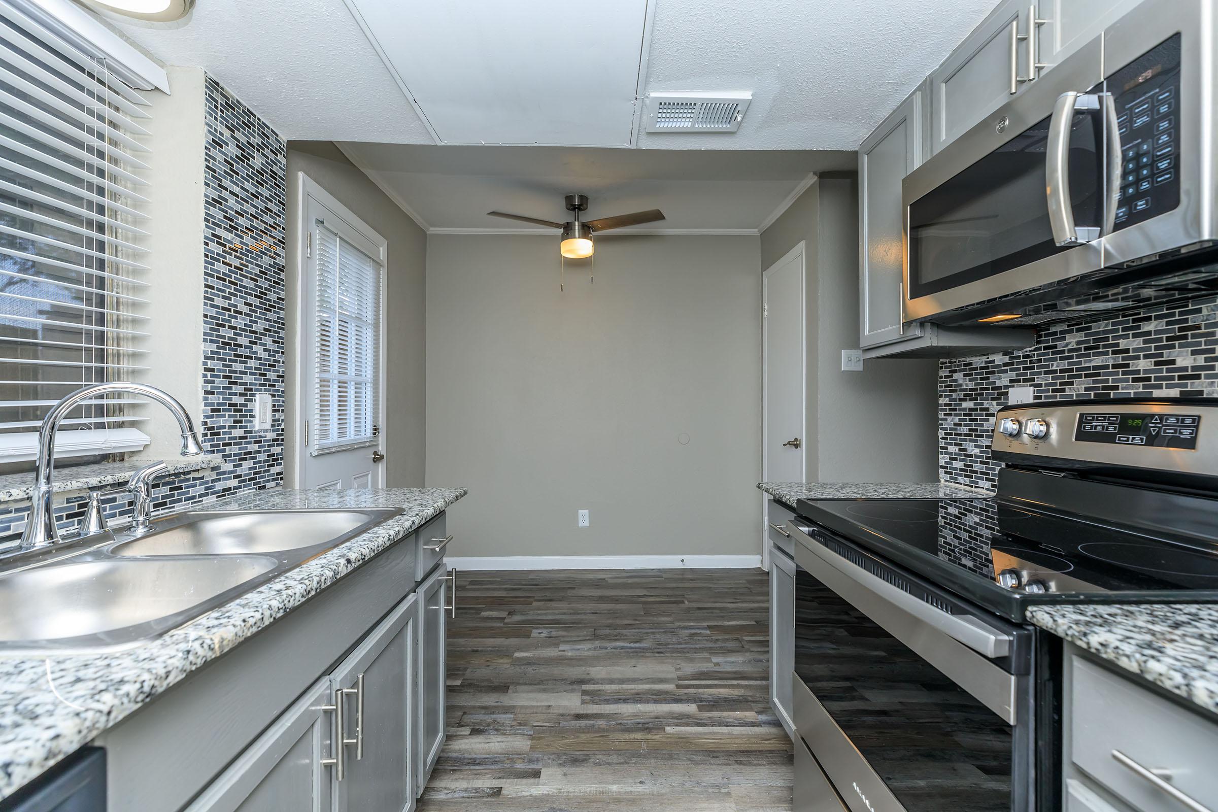 a kitchen area with a building in the background