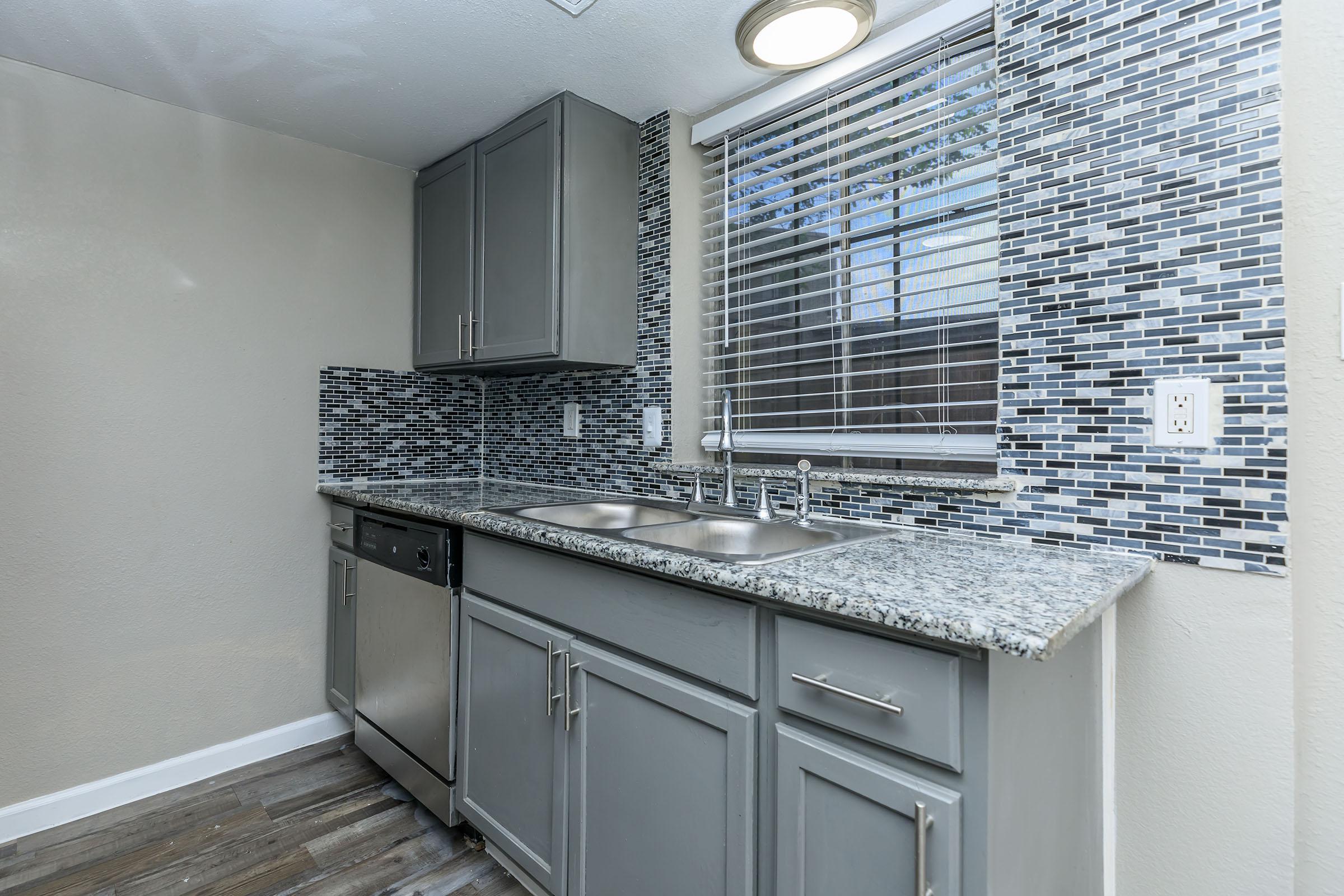 a kitchen with a sink and a window