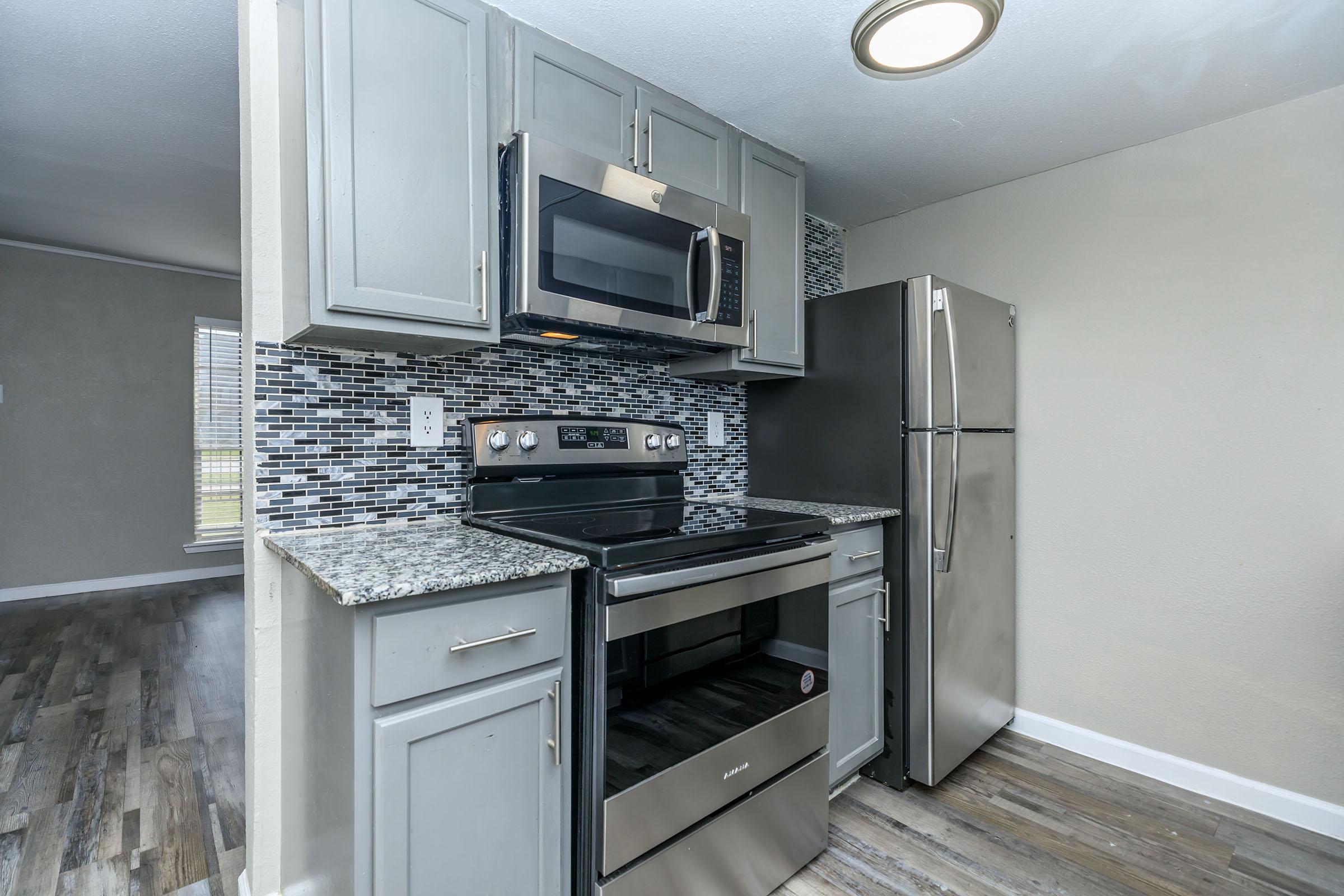 a large kitchen with stainless steel appliances