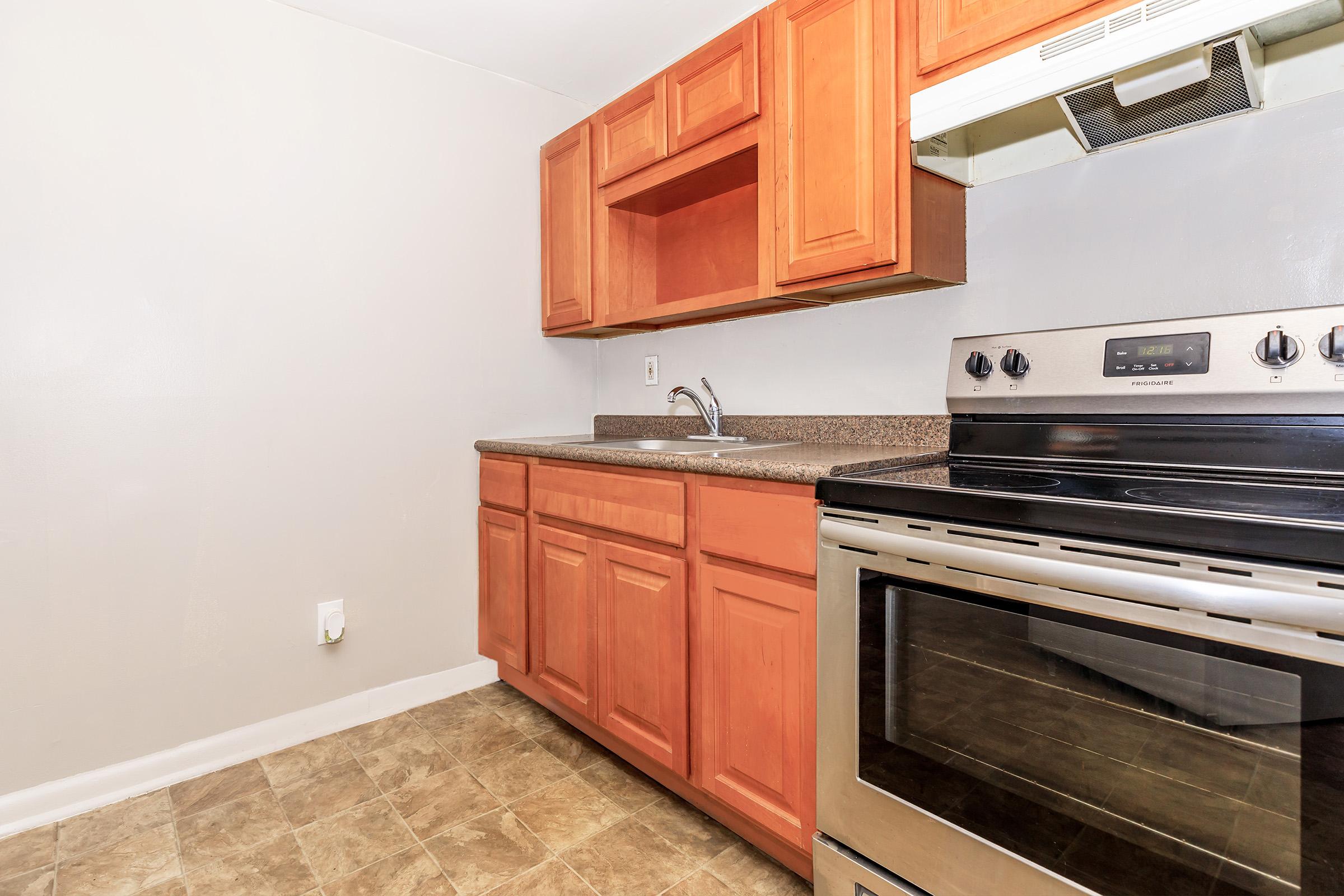 a stove top oven sitting inside of a kitchen