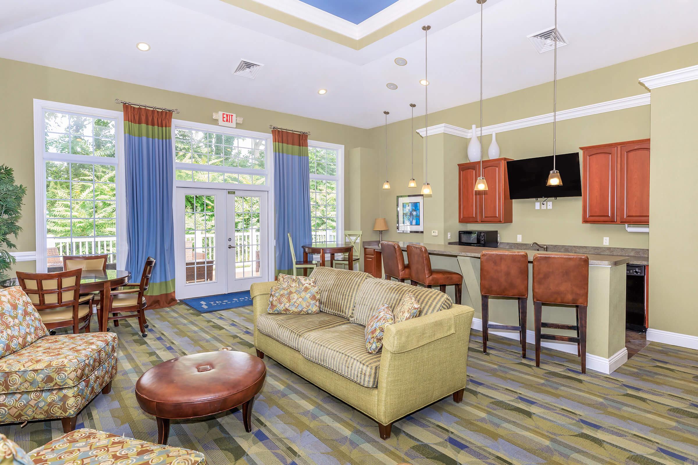 a living room filled with furniture and a large window