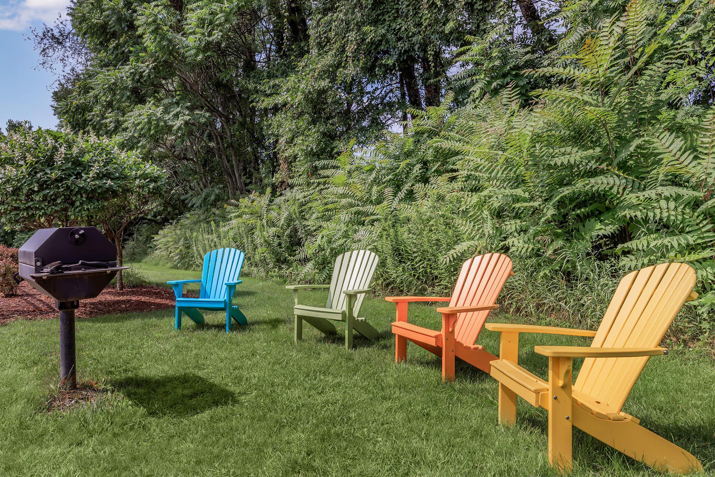 a couple of lawn chairs sitting on top of a wooden bench