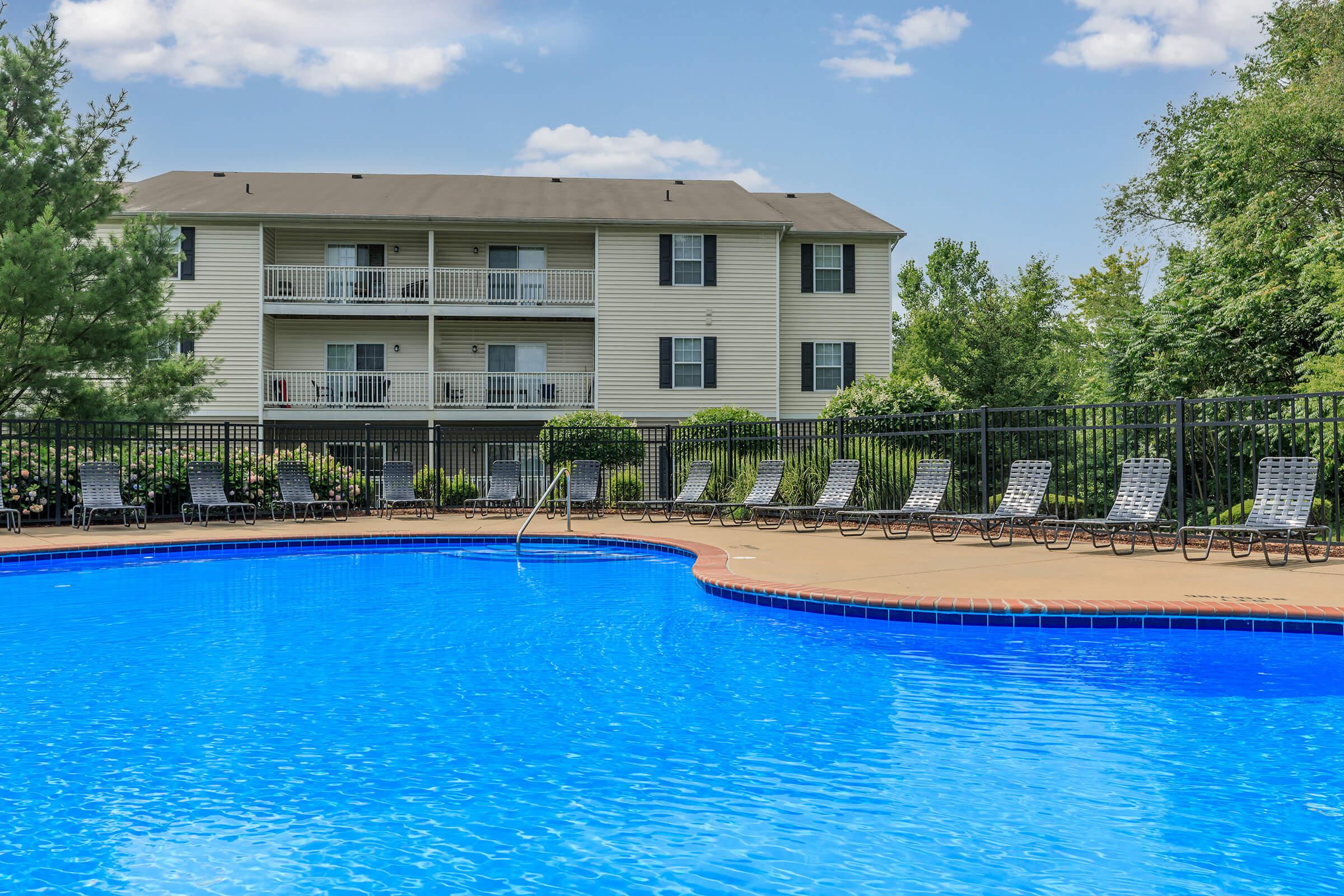 a blue pool of water in front of a building