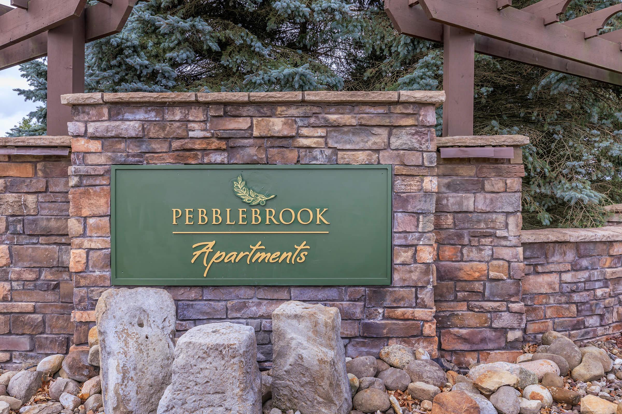 a sign in front of a brick building