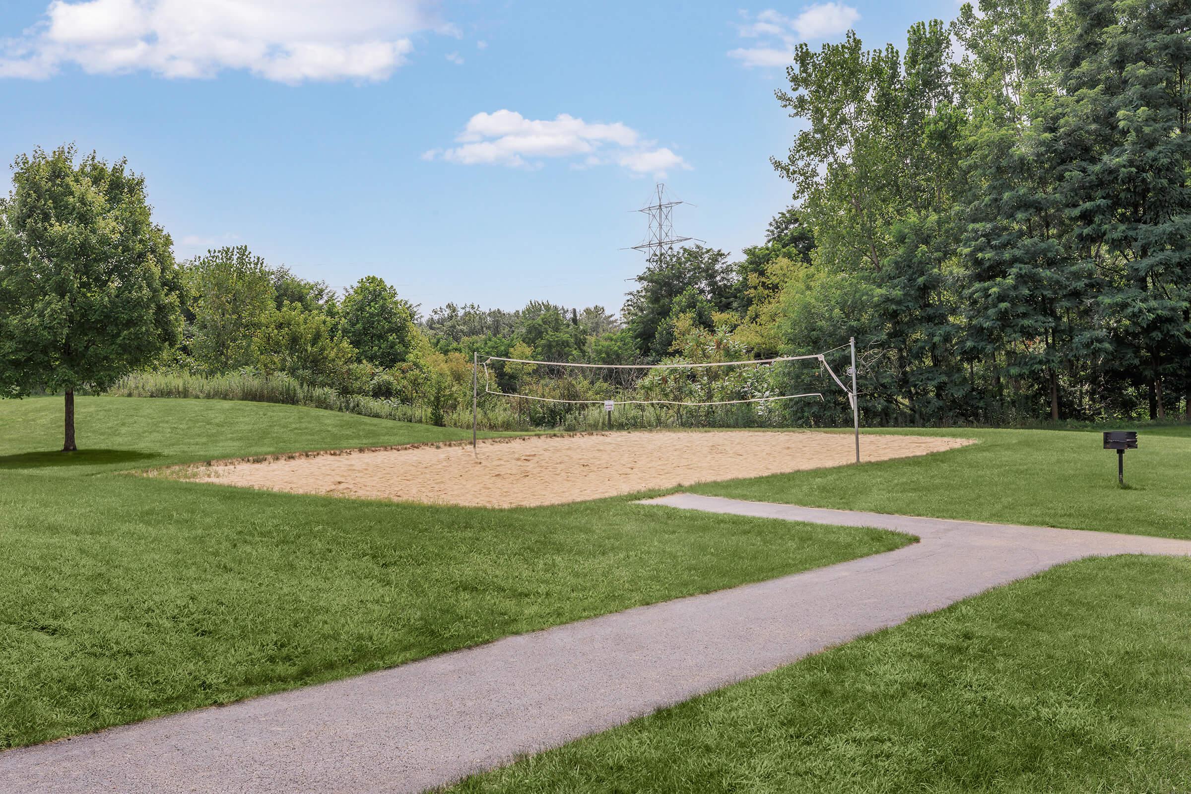 a path with grass and trees