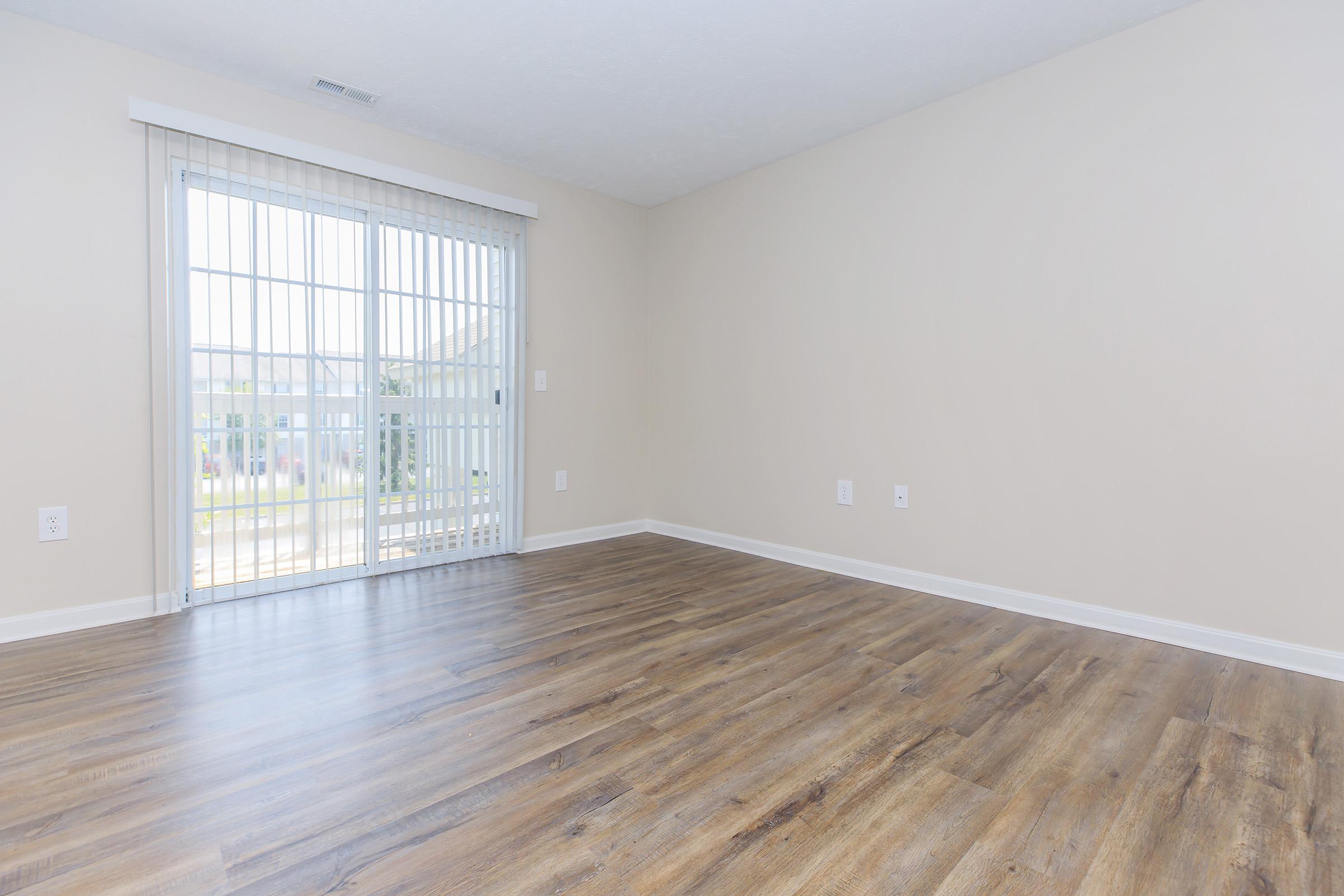 a large empty room with a wooden floor