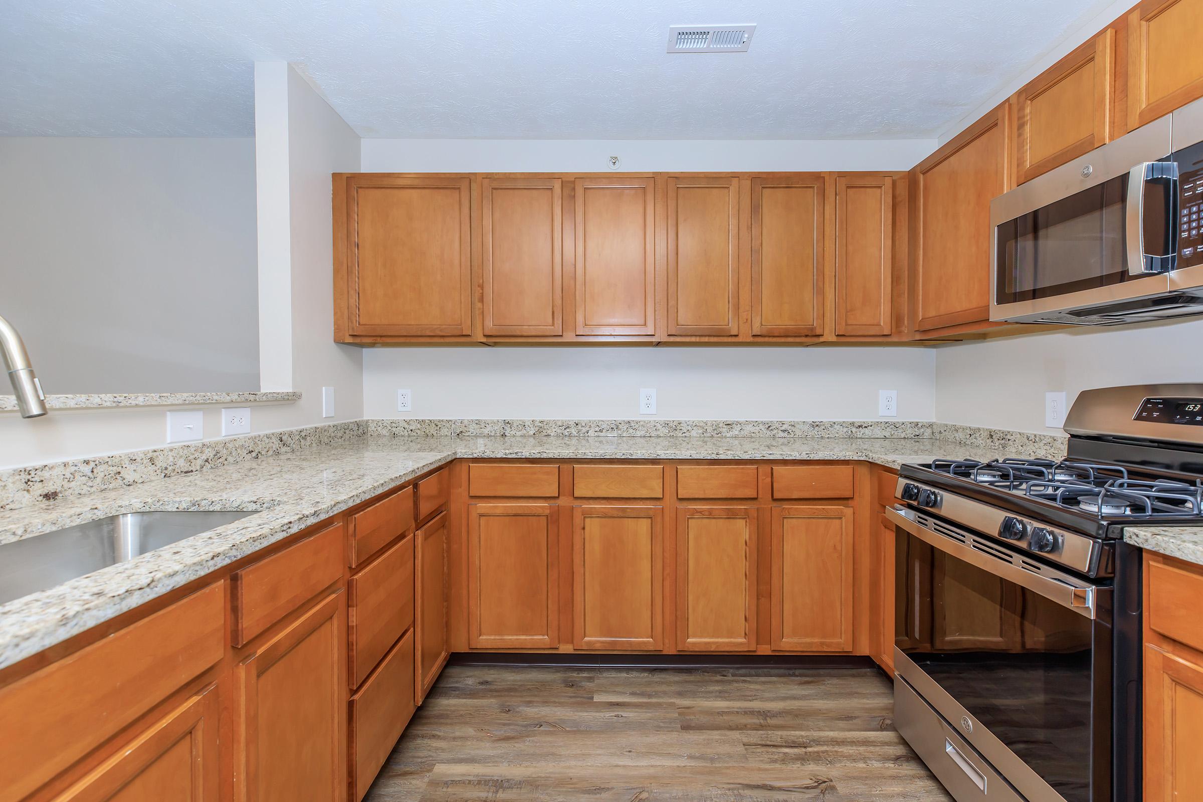 a kitchen with stainless steel appliances and wooden cabinets