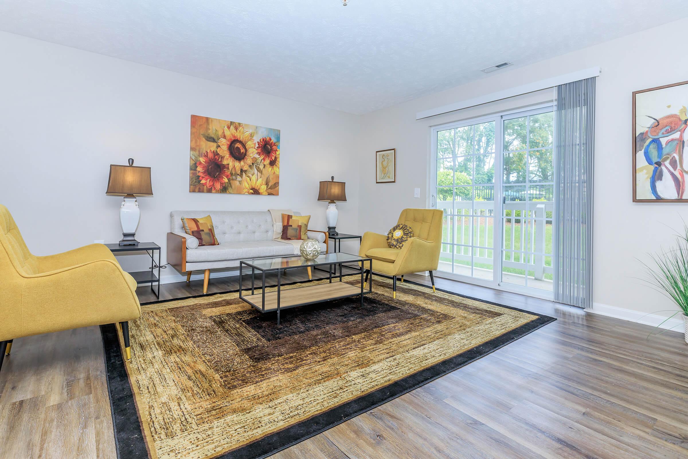 a living room filled with furniture and a large window