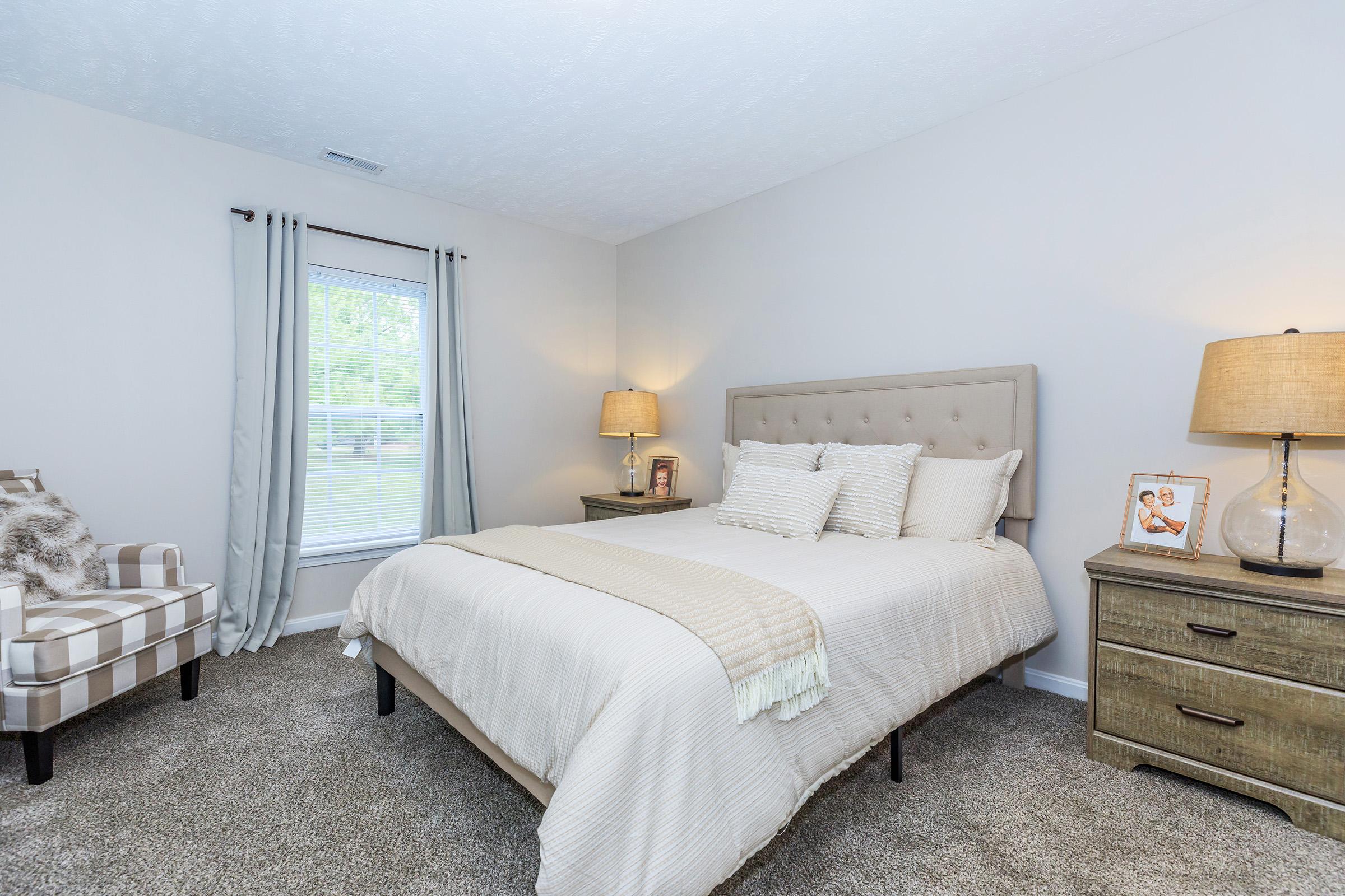 a bedroom with a bed and desk in a room