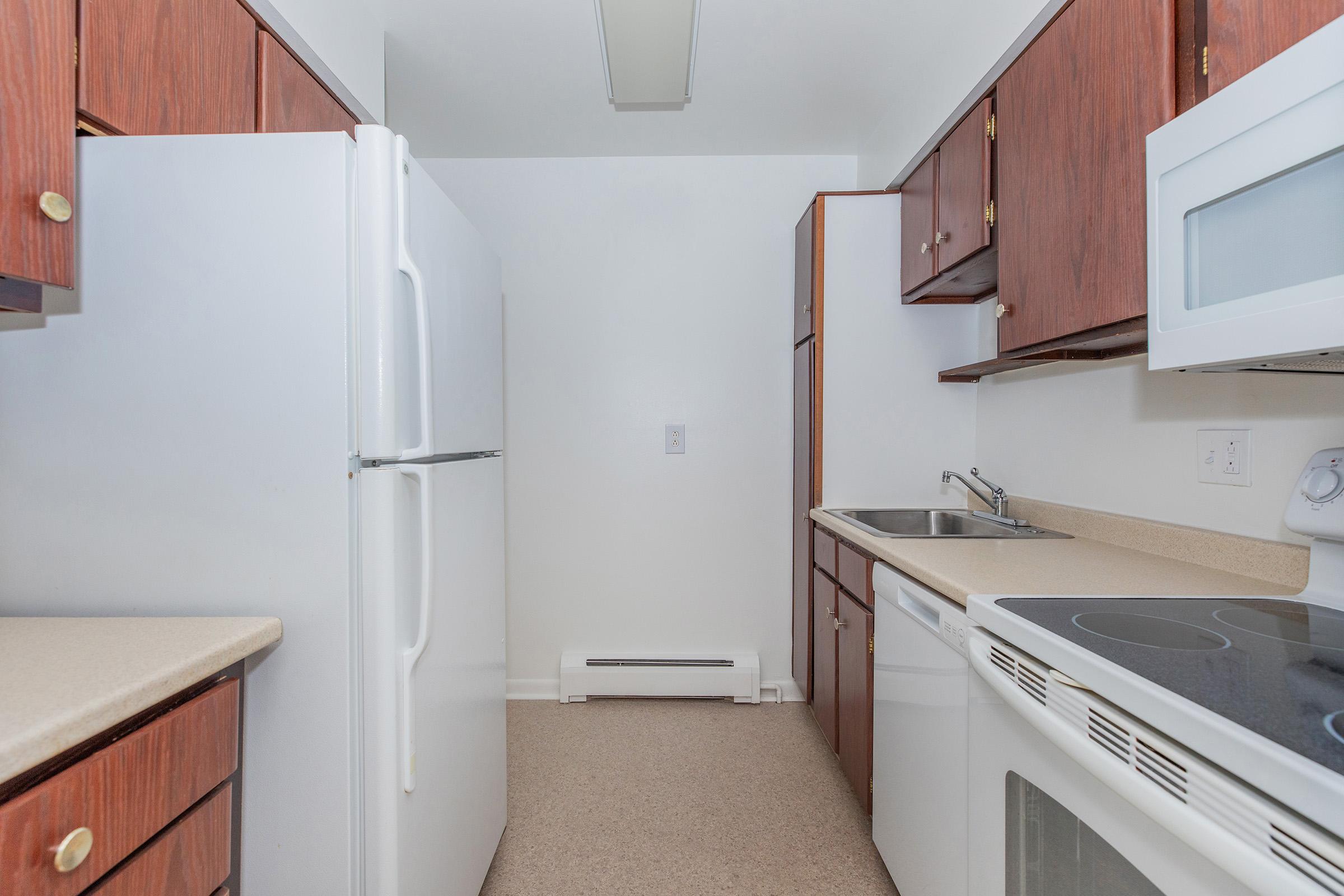 a kitchen with a stove sink and refrigerator