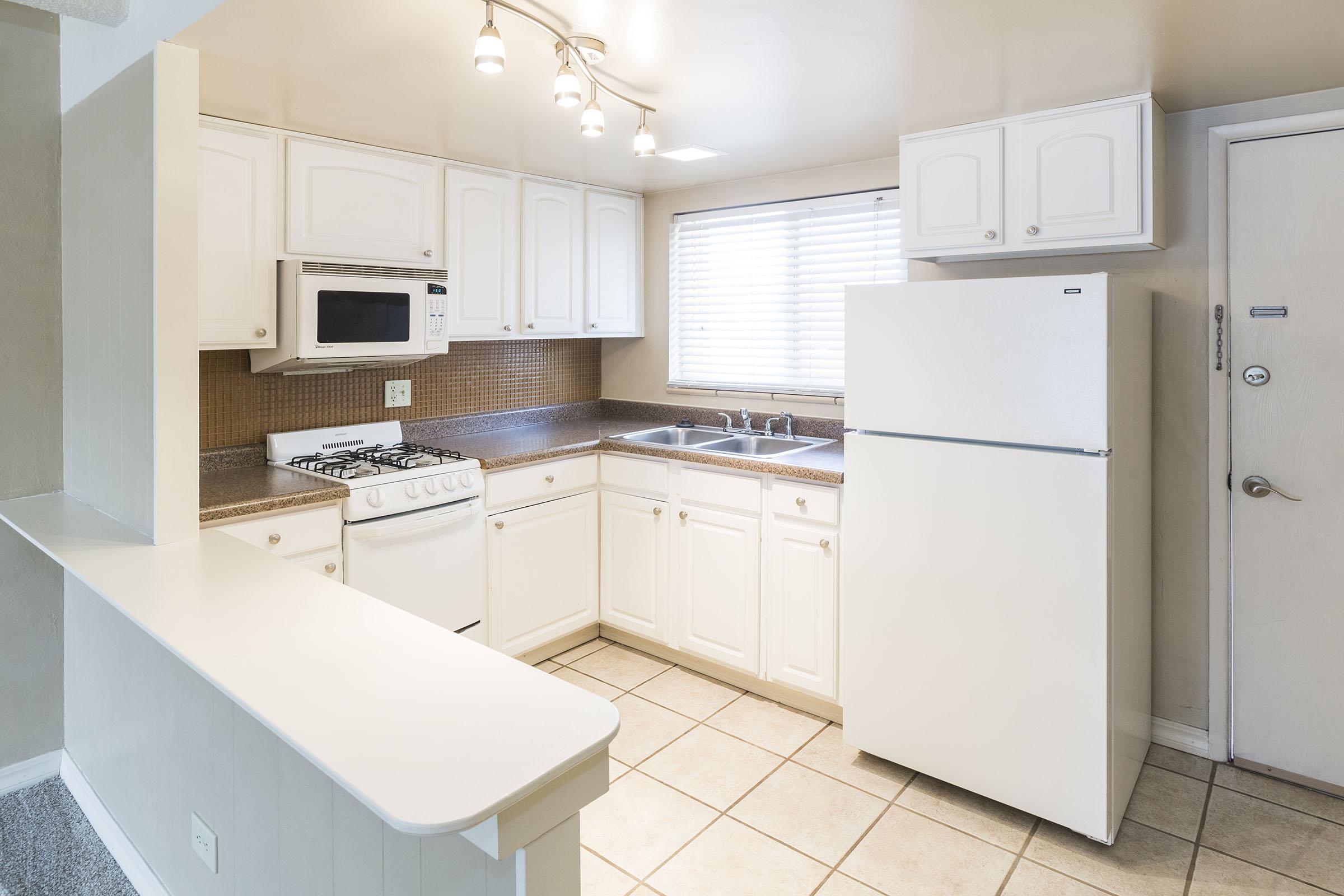 a kitchen with a sink and a window