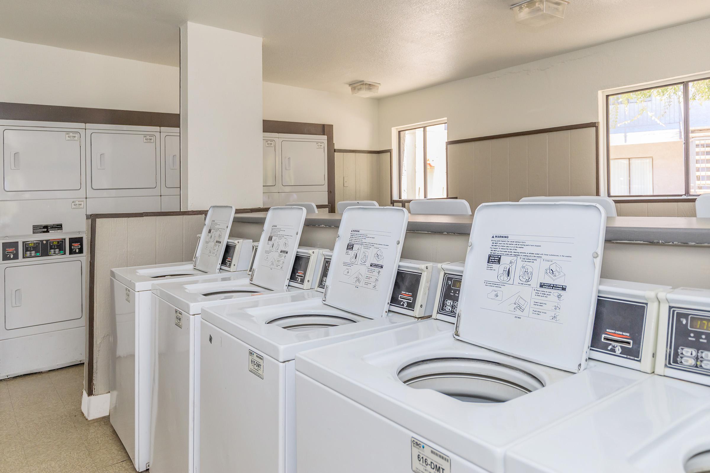 Community laundry facility with washers and dryers at Rise Desert West apartments for rent in Phoenix