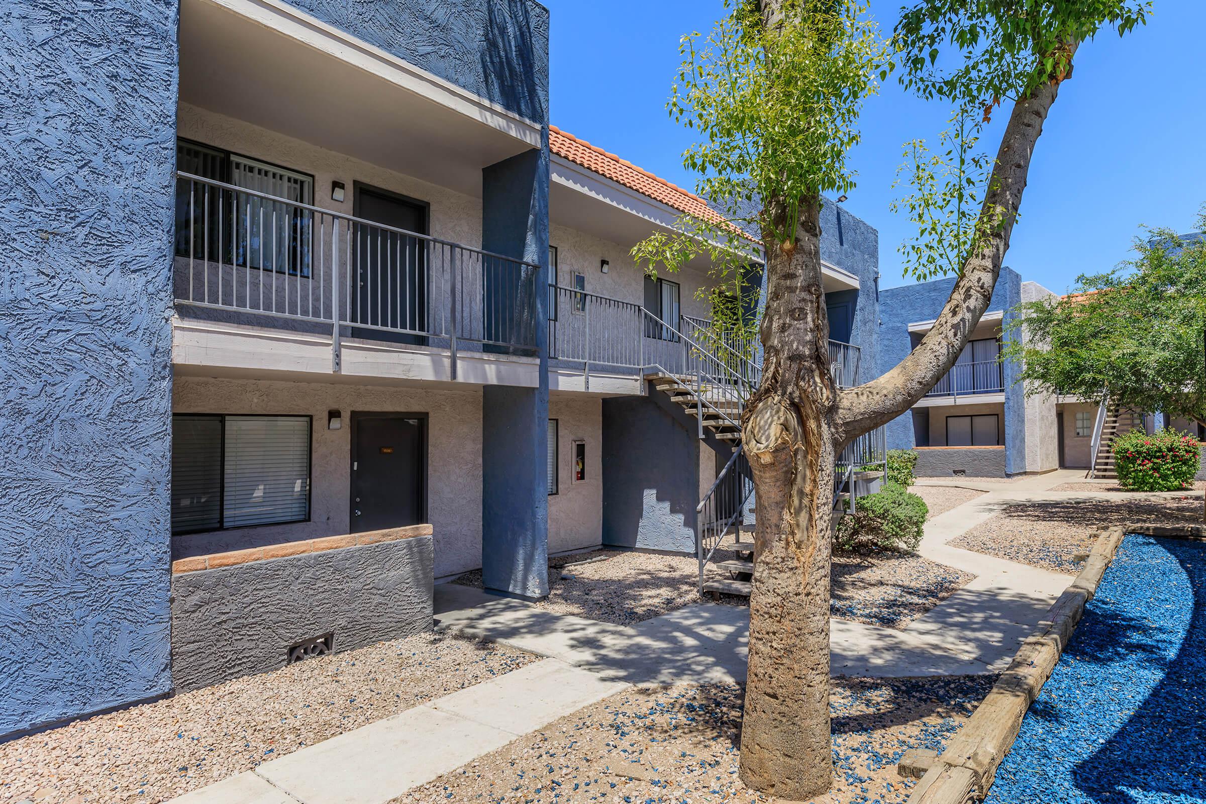 Outdoor pathways leading up to a large two-story Phoenix, AZ apartment building