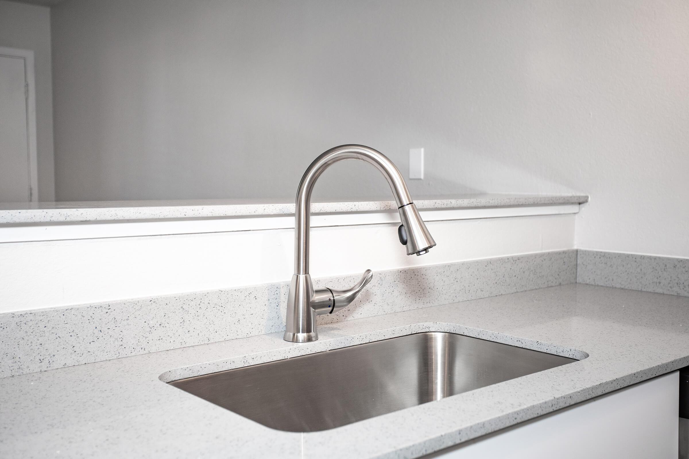 Close up of stainless steel sink and faucet