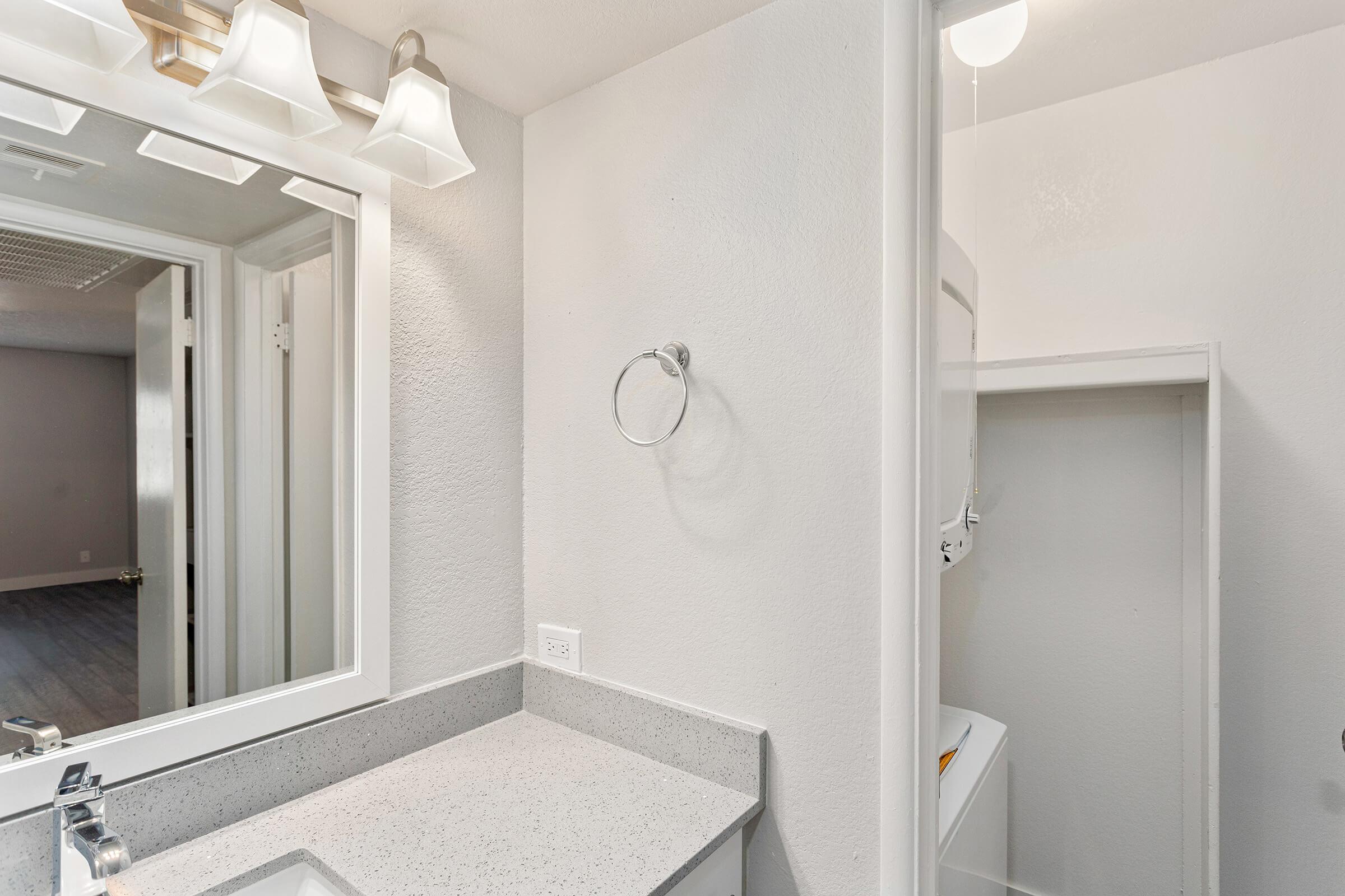 Contemporary modern bathroom besides a stacked washer and dryer