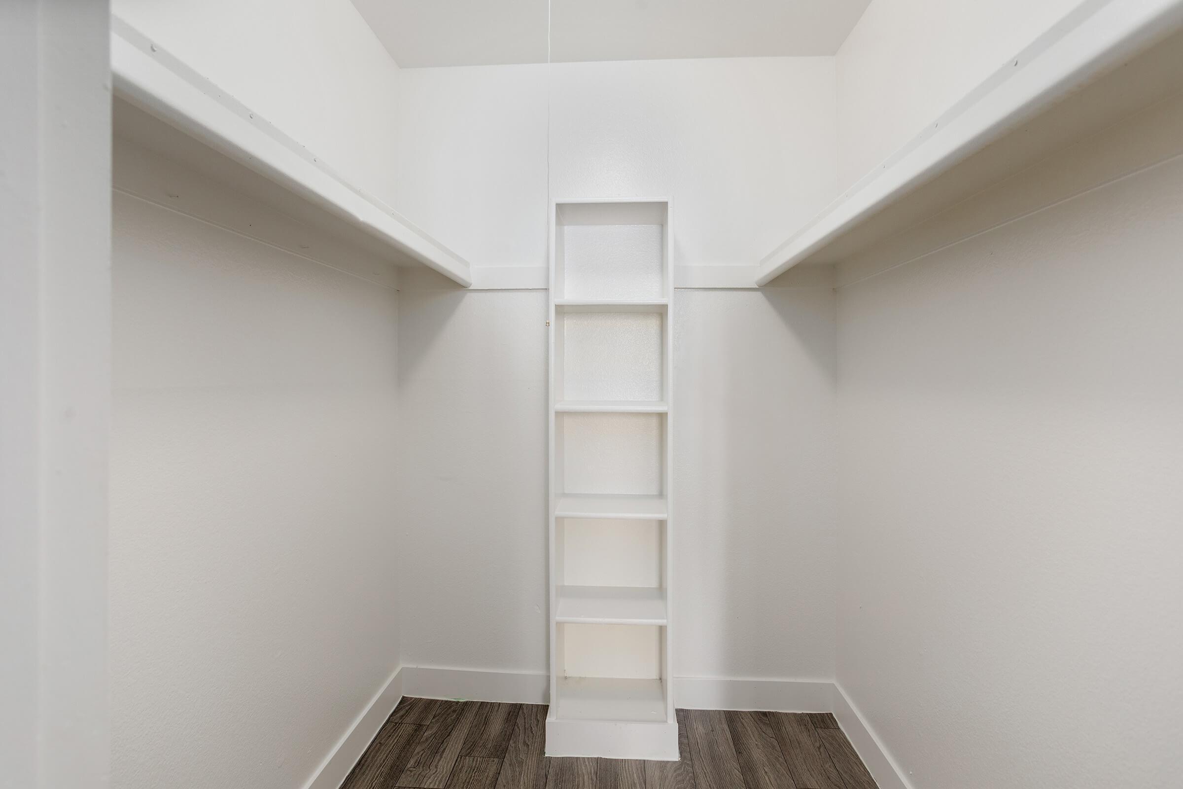 Walk in closet with built in shelving unit