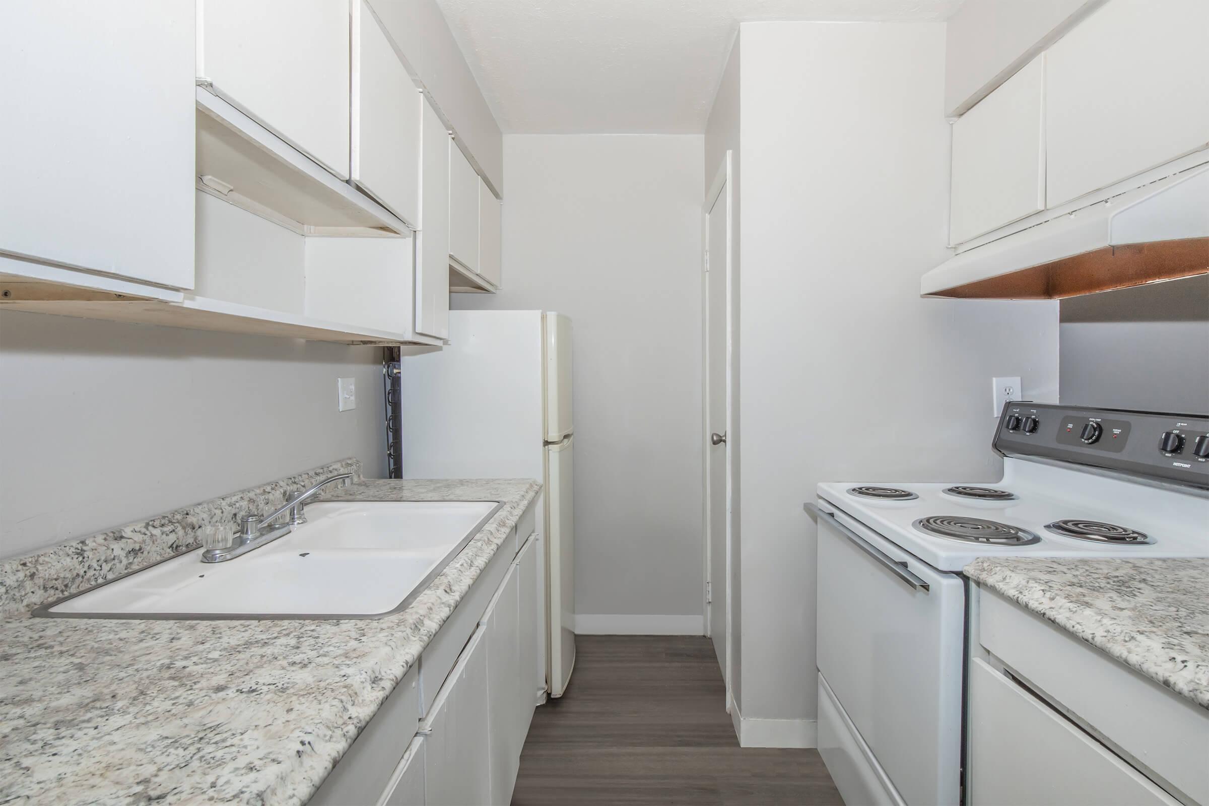 a kitchen with a sink and a mirror