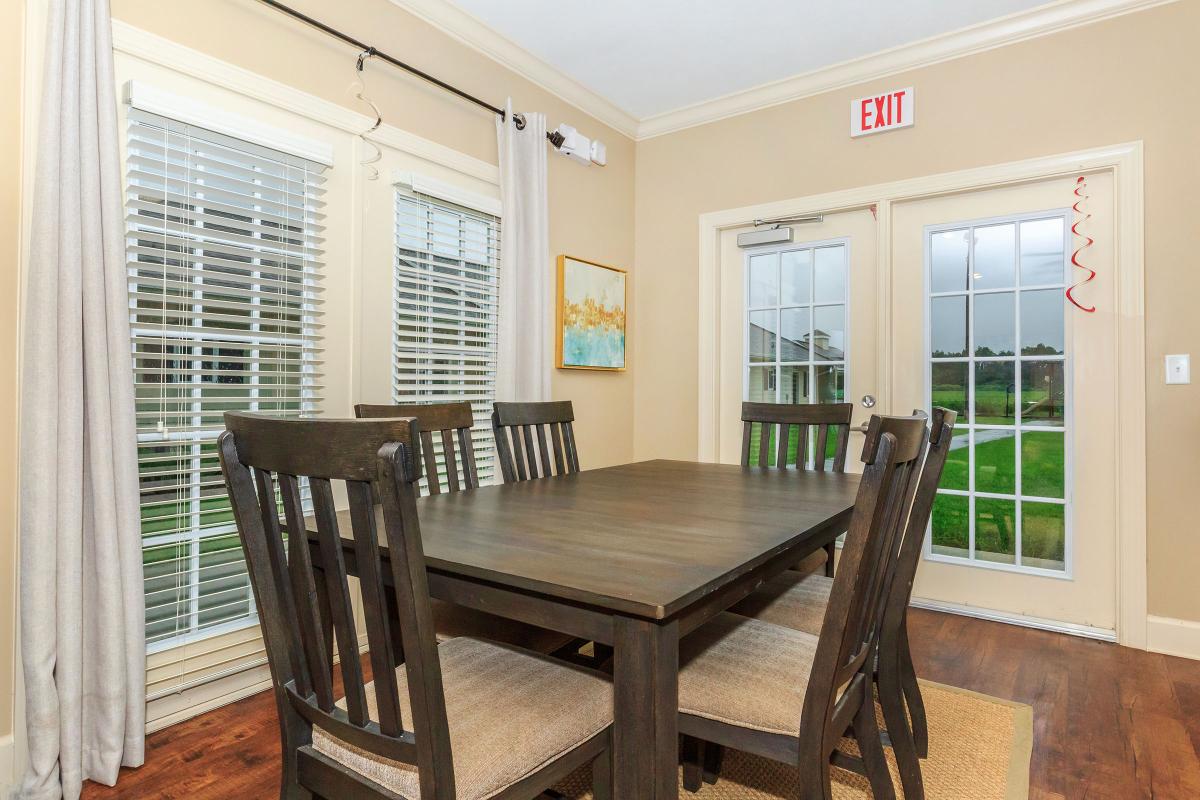 a dining room table in front of a window