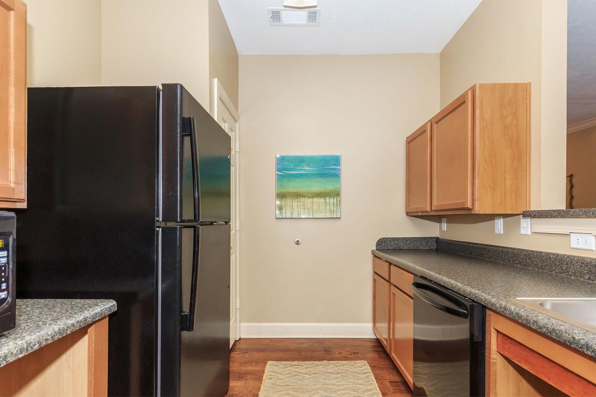 a modern kitchen with stainless steel appliances and wooden cabinets