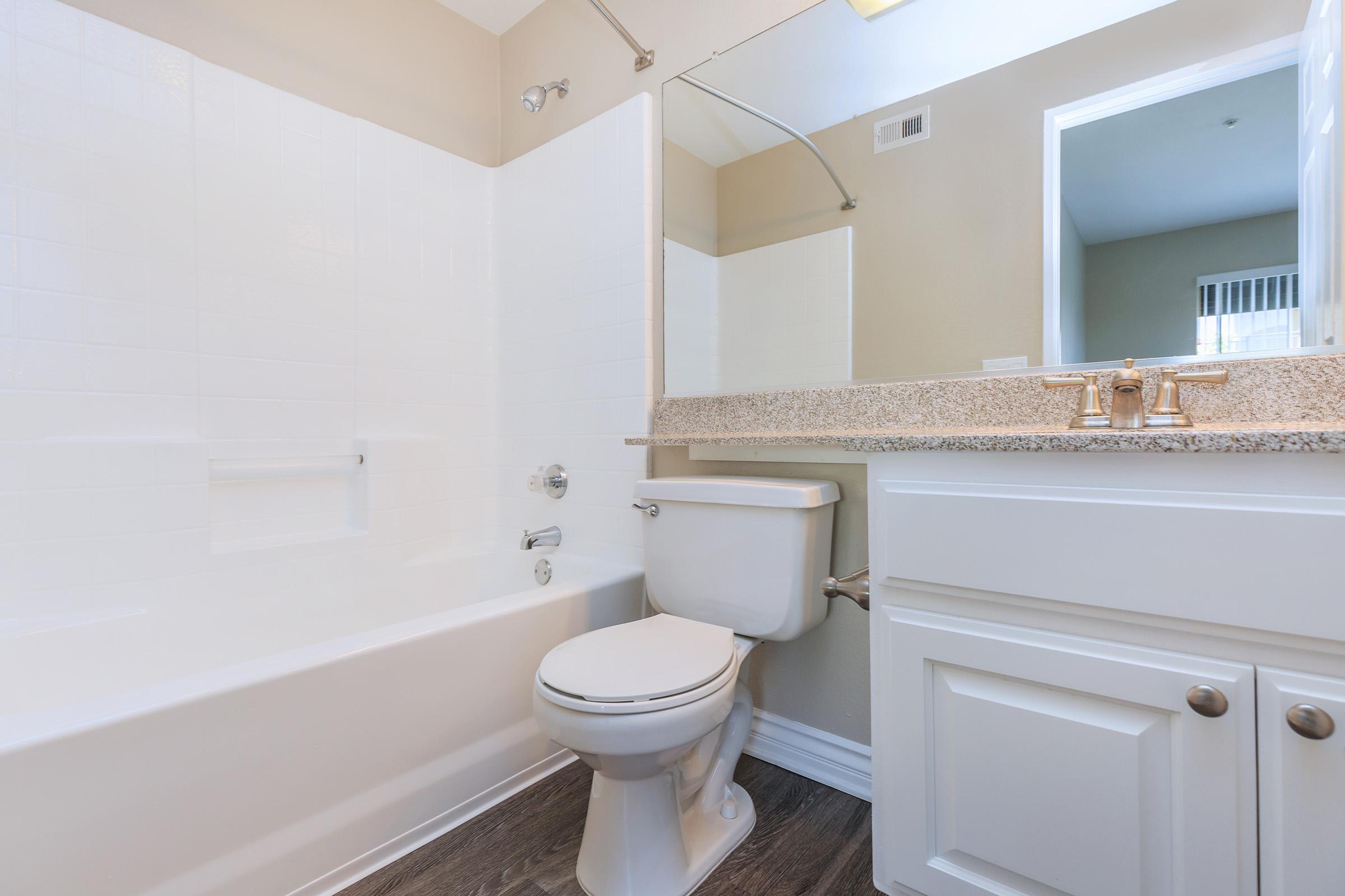 Unfurnished bathroom with white cabinets