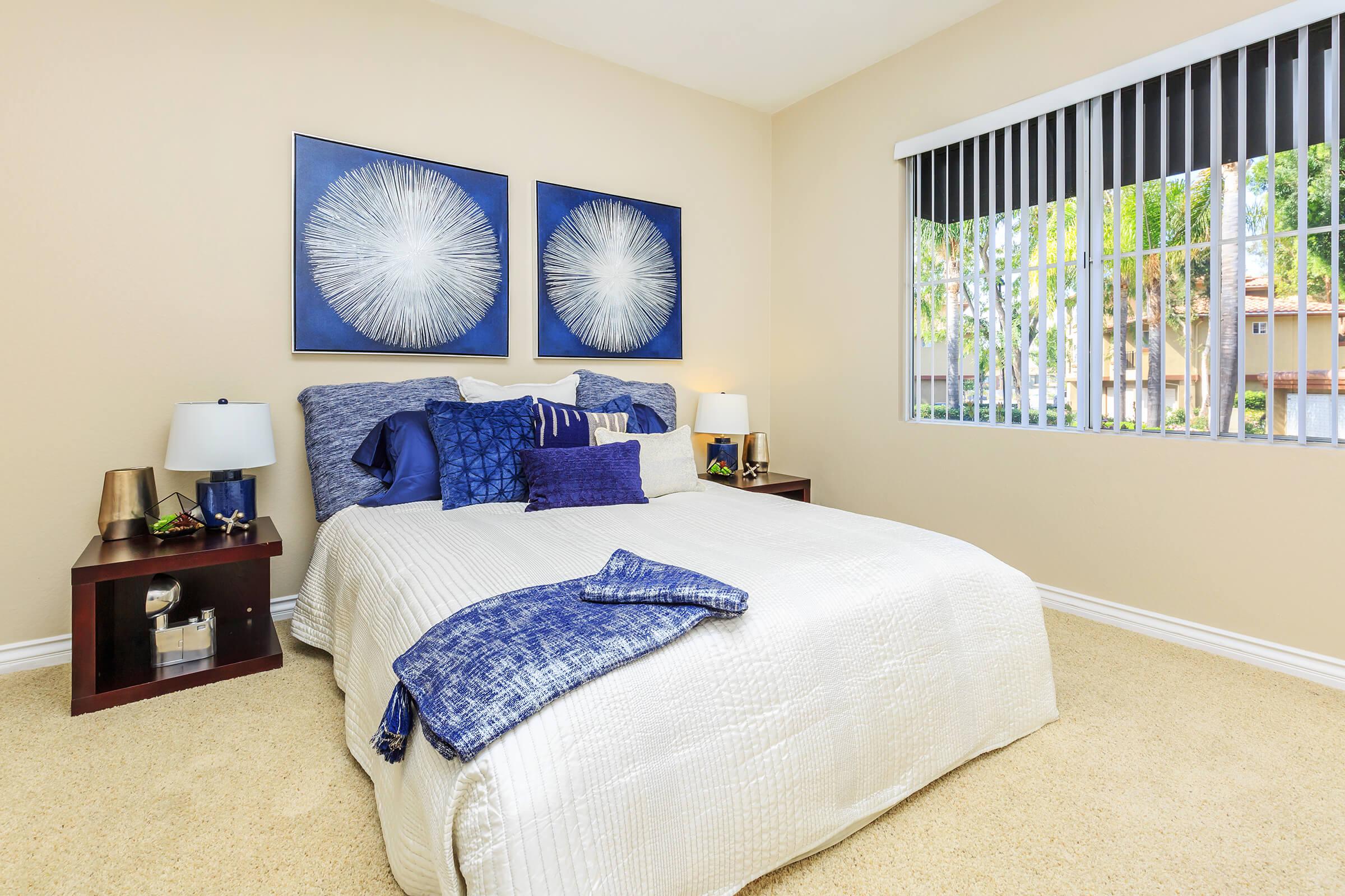 Bedroom with white and blue bedding