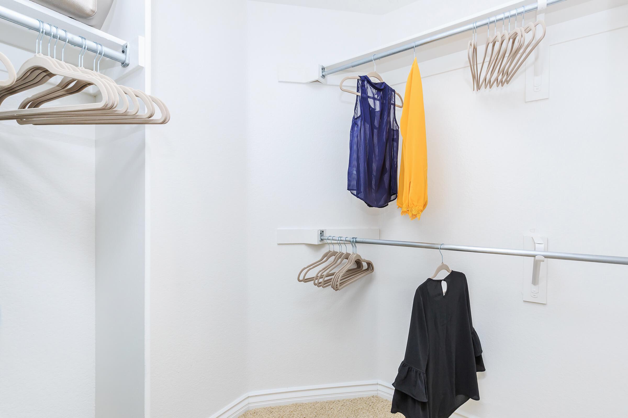 Walk-in closet with hangers and clothes